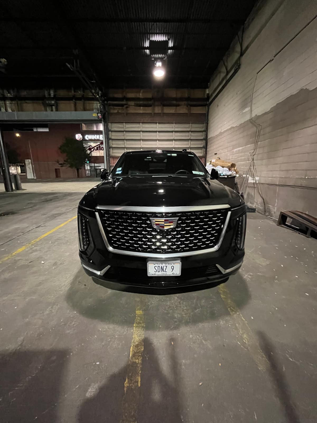 Black Cadillac Escalade parked in the NYC Car Wraps shop before wrapping, front view