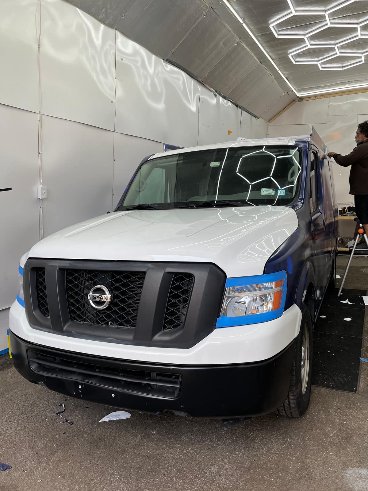NYC Car Wraps installers wrapping a cargo van inside the Long Island City shop