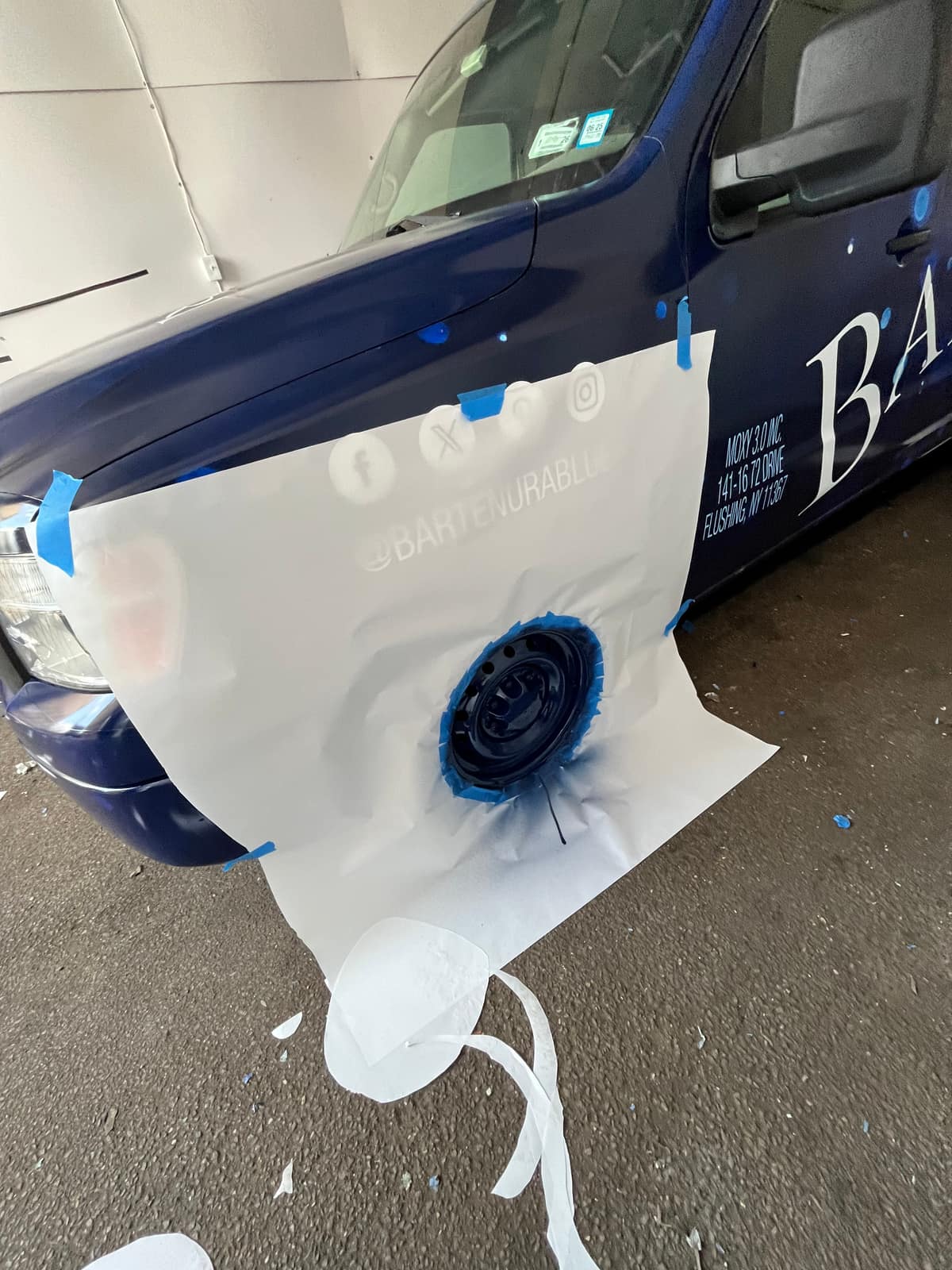 Close-up of a wheel arch being trimmed during a full van wrap install