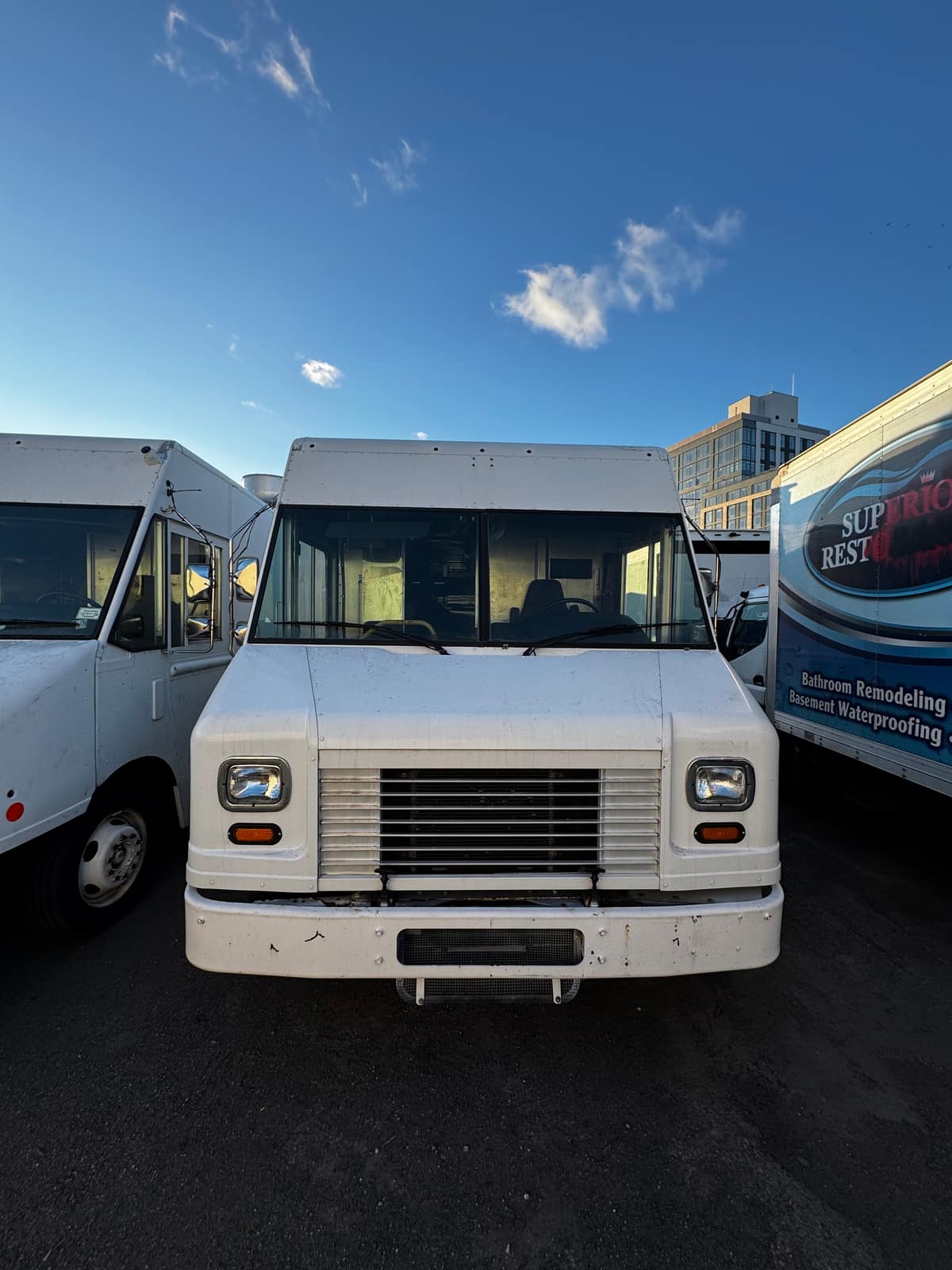 Plain white step van outdoors before wrapping